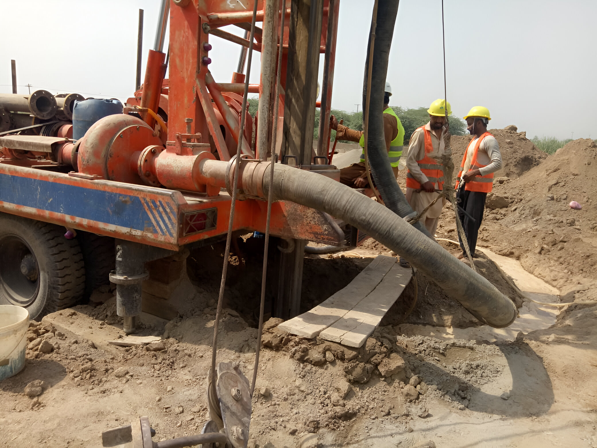 An image of a specialized water drilling vehicle equipped with machinery and tools, designed to penetrate the earth's surface to access underground water sources