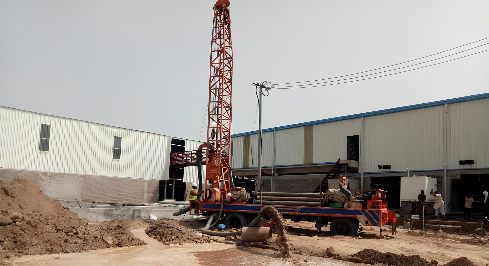 An image of a specialized water drilling vehicle equipped with machinery and tools, designed to penetrate the earth's surface to access underground water sources