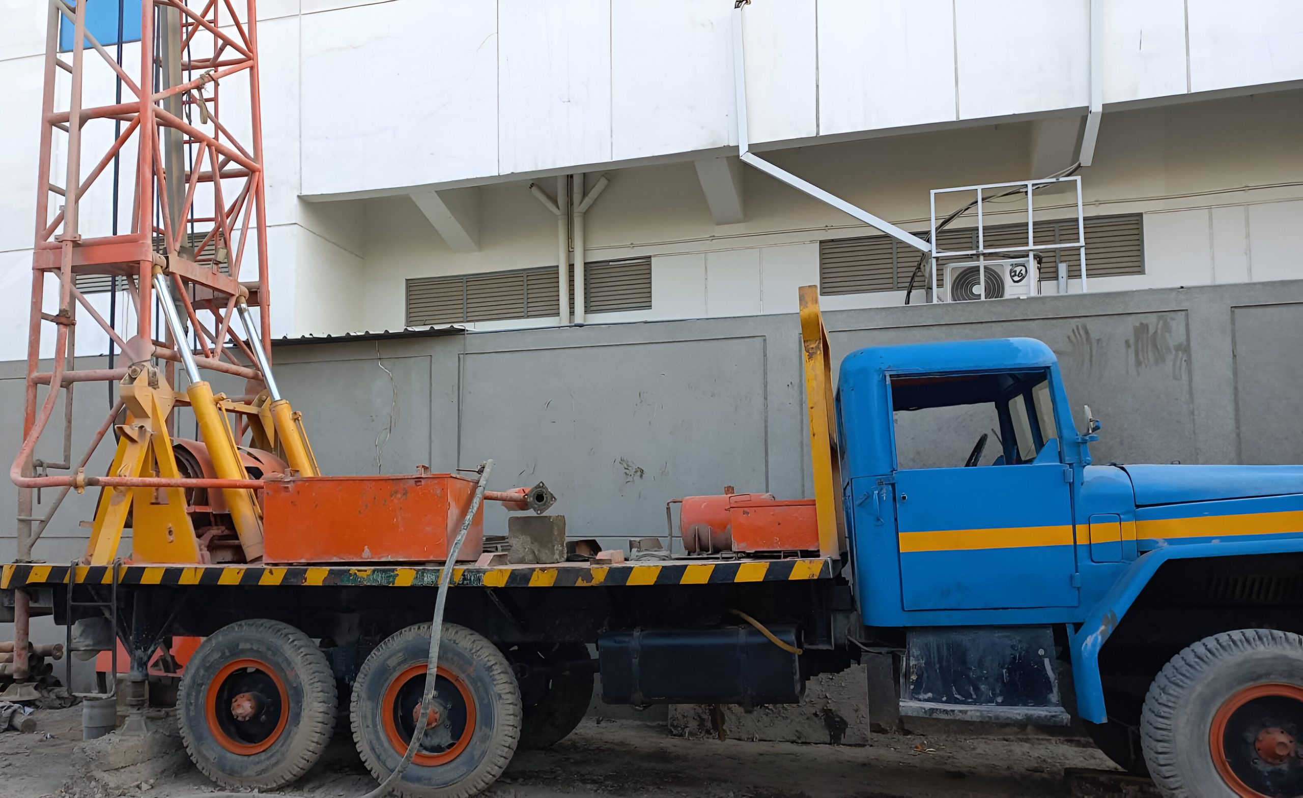 An image of a specialized water drilling vehicle equipped with machinery and tools, designed to penetrate the earth's surface to access underground water sources