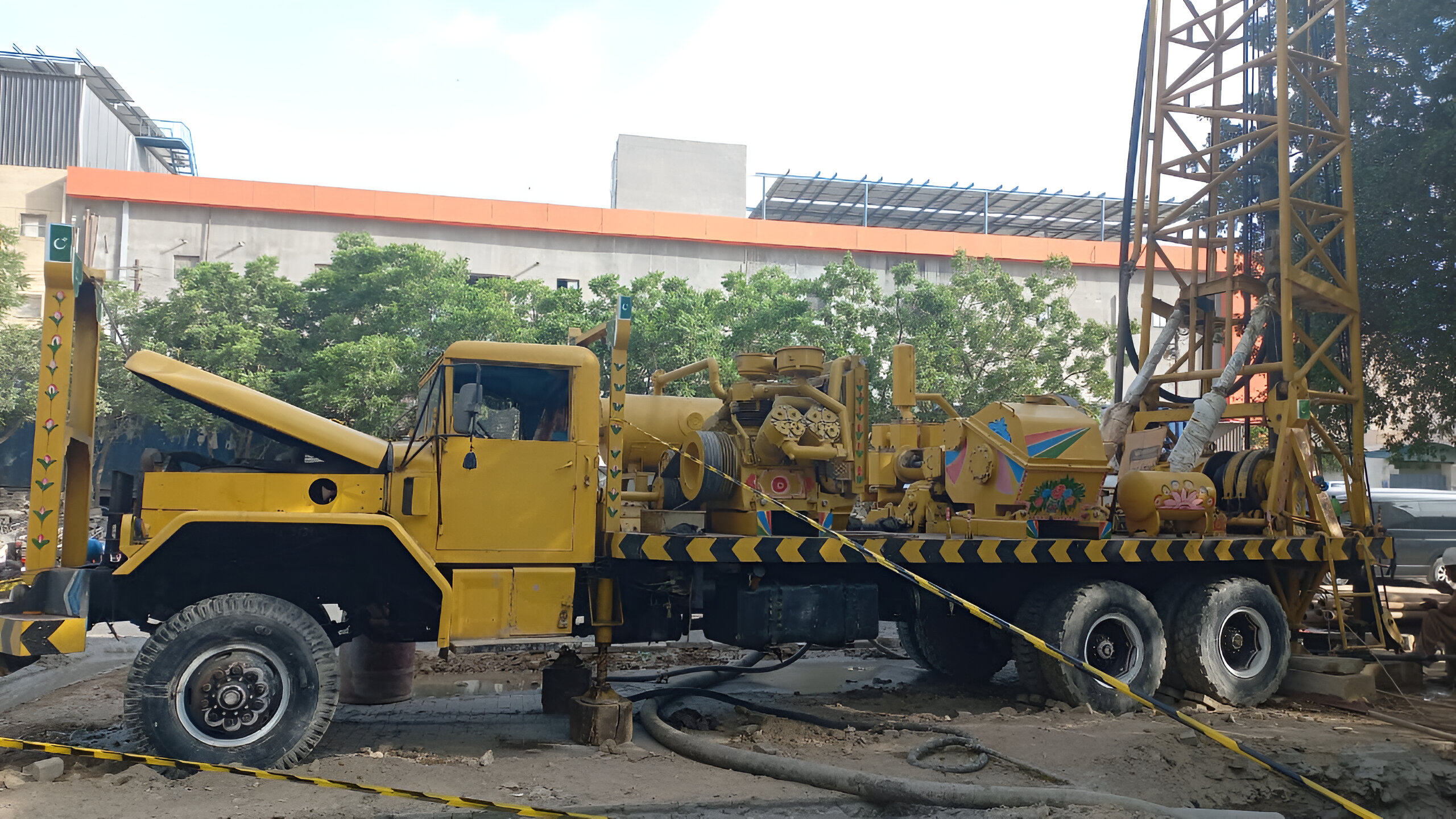 An image of a specialized water drilling vehicle equipped with machinery and tools, designed to penetrate the earth's surface to access underground water sources