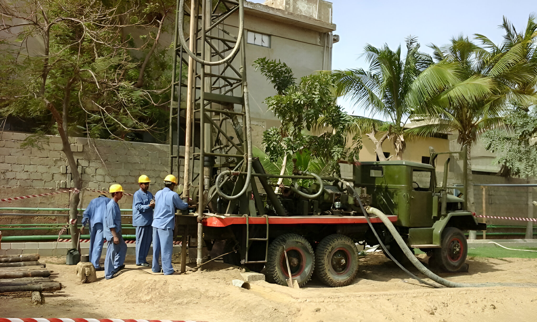 An image of a specialized water drilling vehicle equipped with machinery and tools, designed to penetrate the earth's surface to access underground water sources