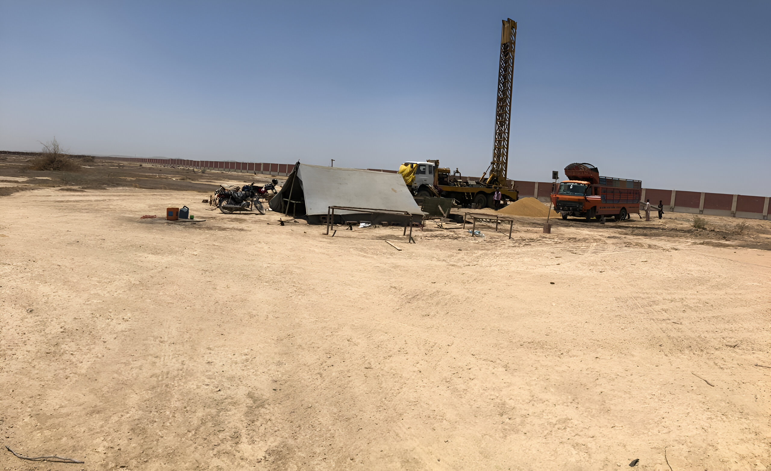 An image of a specialized water drilling vehicle equipped with machinery and tools, designed to penetrate the earth's surface to access underground water sources